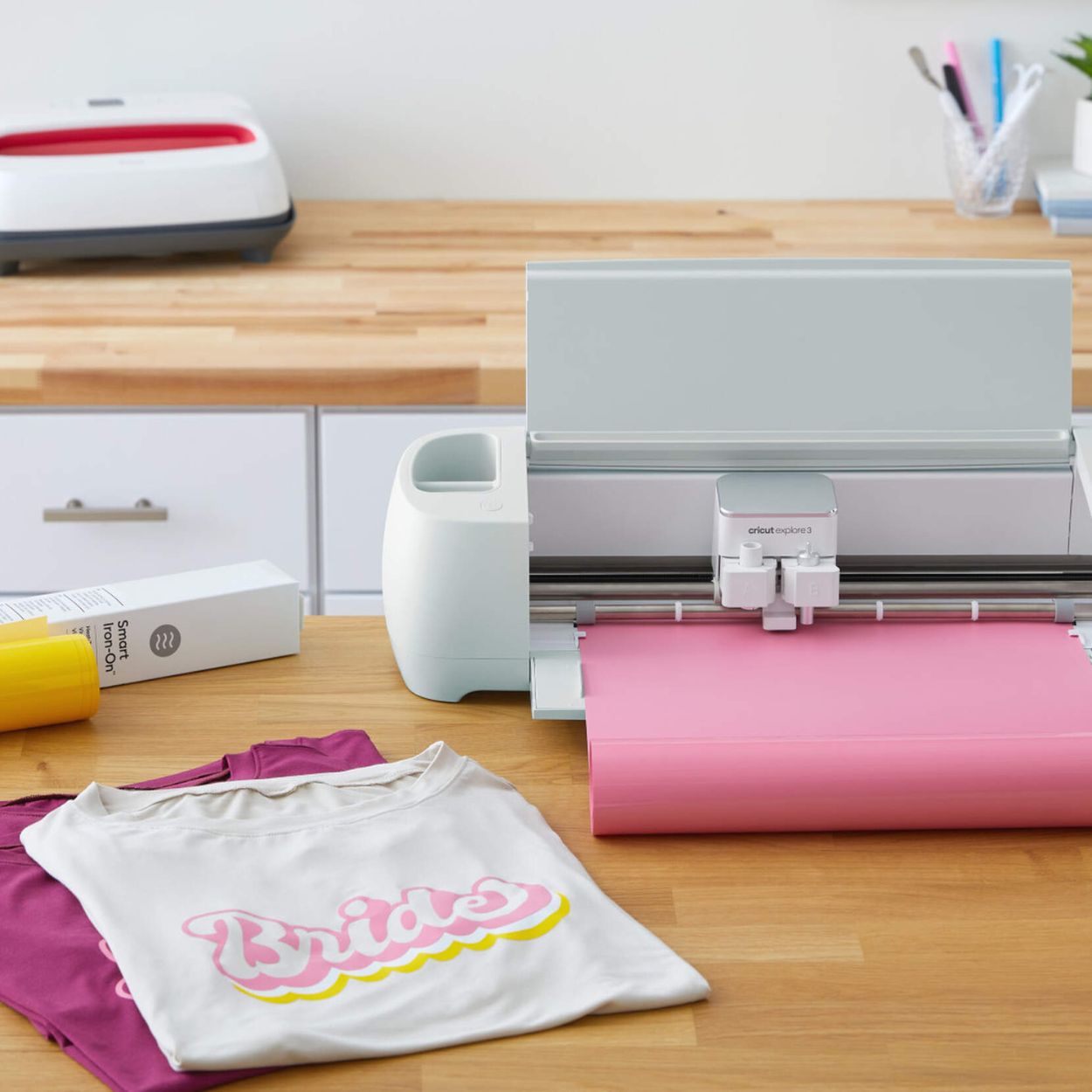 Cricut Explore 3 cutting Smart Iron-on Vinyl to make "Bride" shirt